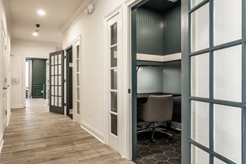 a study area with a desk and chair in a 555 waverly unit